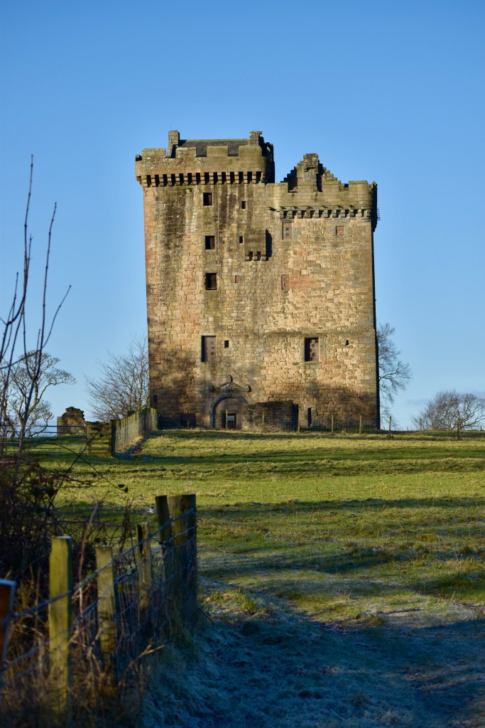 Another front view, photo taken from distance, with fence in foreground.