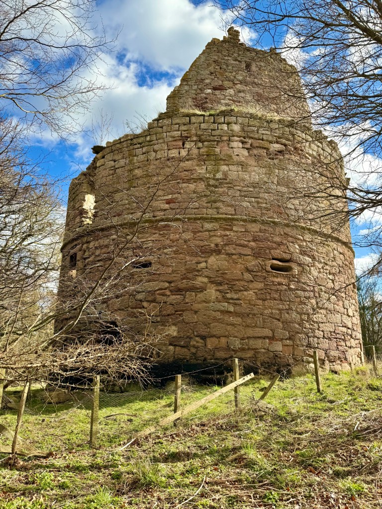 view from behind the tower, looking upwards. Good view of the round military tower. Gun shot slits are clearly visible.