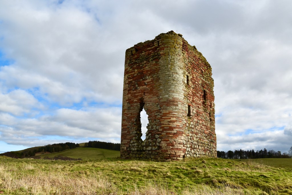 Corsbie Tower. View from south west, showing hole in western wall and rounded corner.