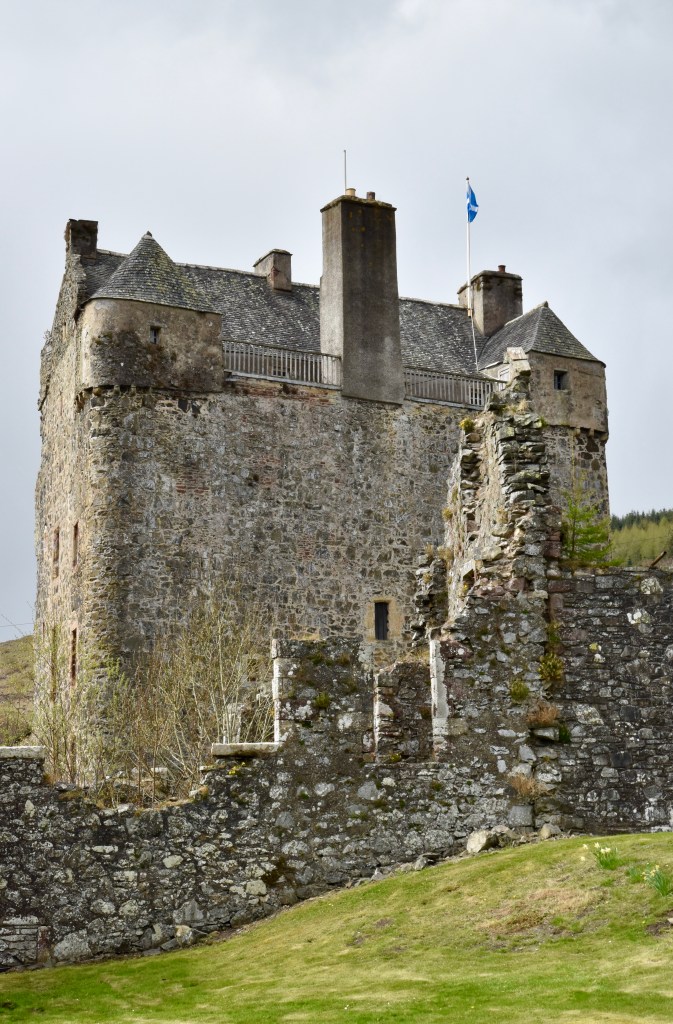 Another front view, taken outside of the courtyard wall. The parapet, a large chimney and corner turrets dominate the the top part.
