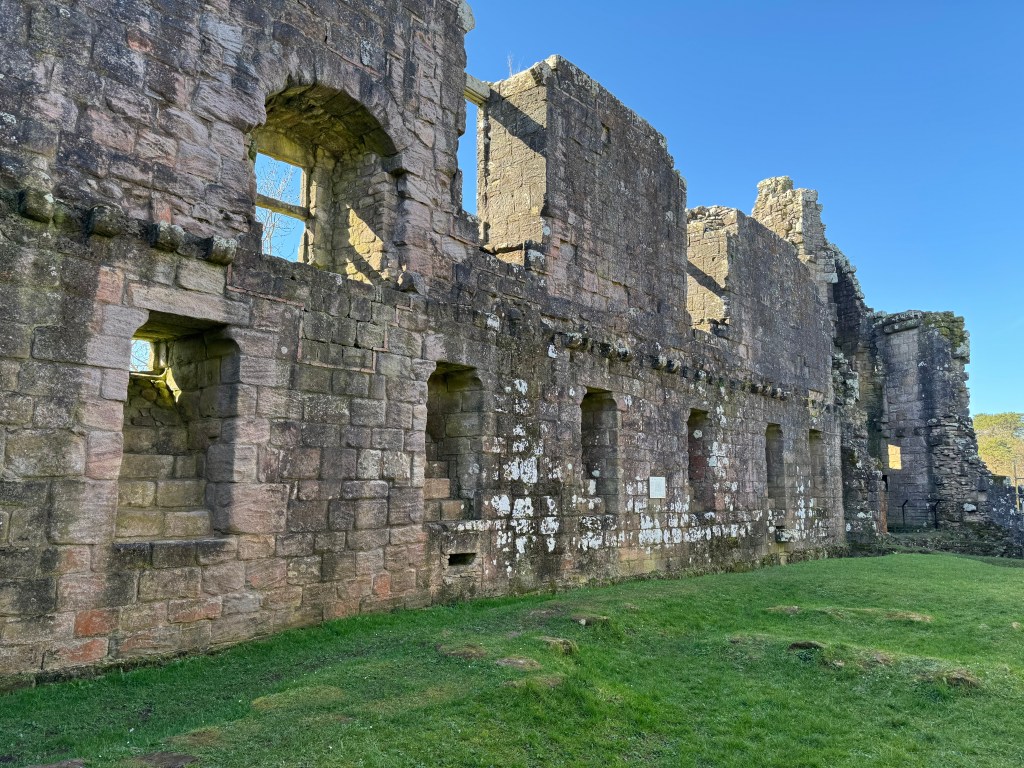 Inside wall showing stepped recesses in a line that lead to smaller oenings at the top of the ground floor