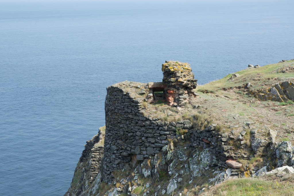 Close up of the wall fragment , located precariously on the cliff edge.