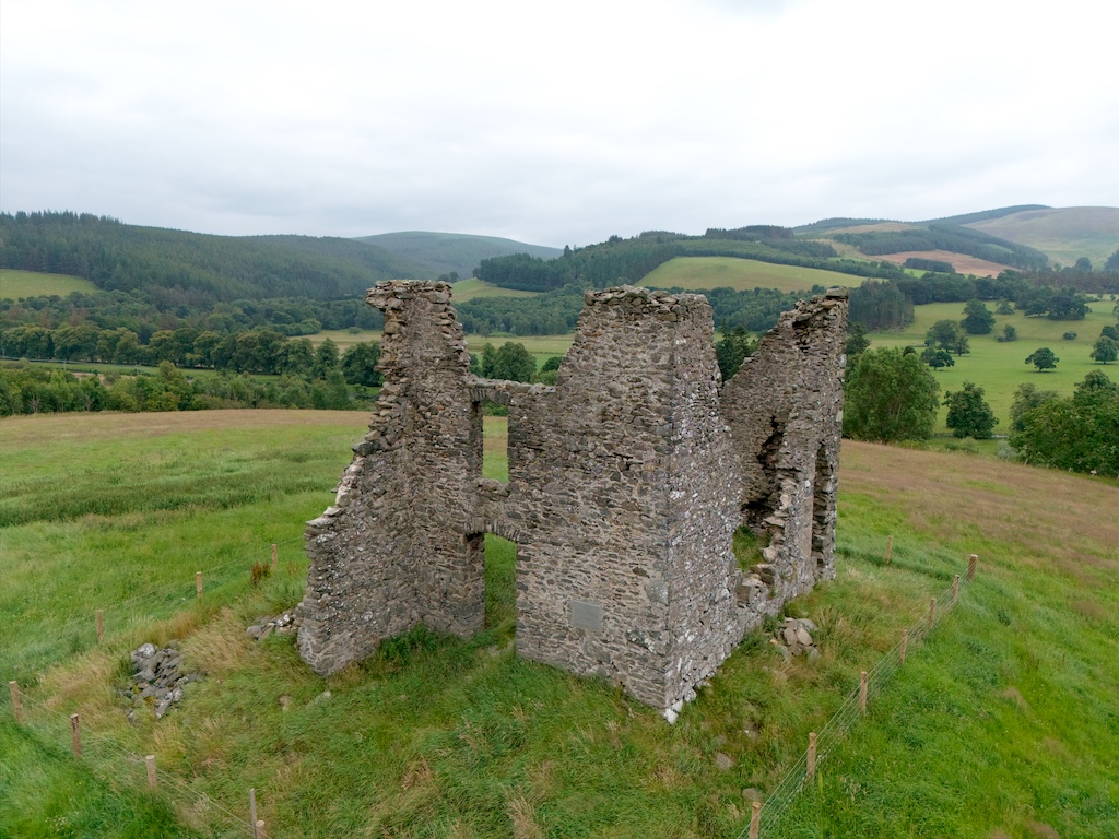 Low level drone shot. with the remaining part of the wing protruding on the left, and the main block behind.
