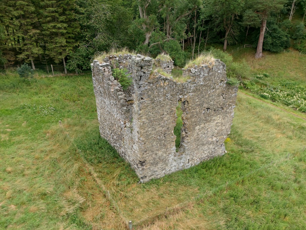 looking down on the tower, again showing the severe damage, including a missing section on the right and the hole ointment the facing wall.