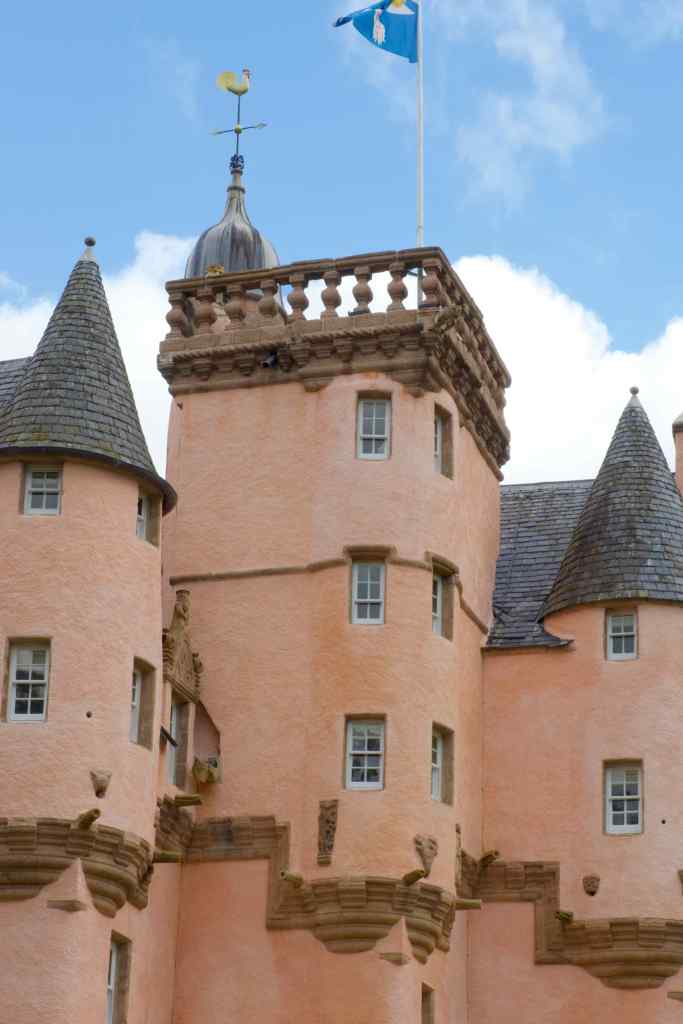 Close-up of the top of the central tower plus two turrets. Plenty of intricate details visible (gargoyles, corbelling etc.