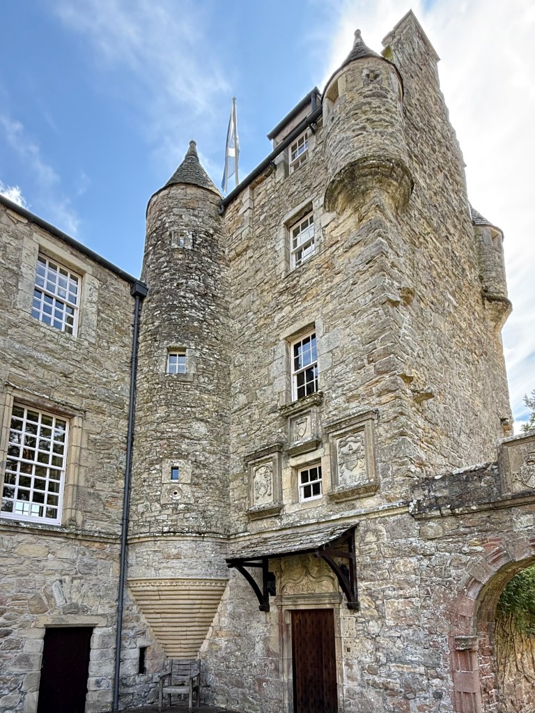 Grey stone tower house , built into the remaining mansion. Ornate turrets.
