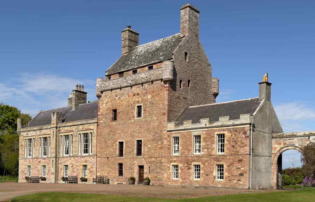 Viwe of the entire house from the south east, showing the arch at the east of the building. The windows in the wing are considerably larger than those of the tower.