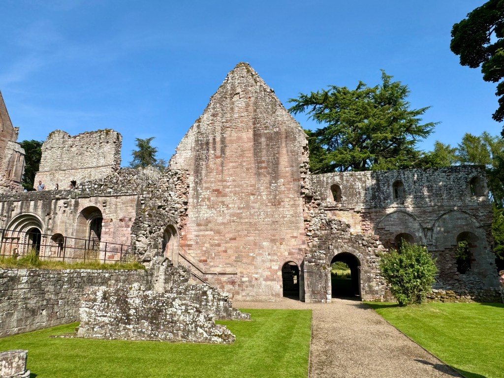 Gable end and walls protruding either sides, with arched entrances and windows