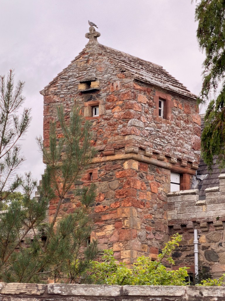 Closer view of stair tower and cathouse, showing detailed stonework.